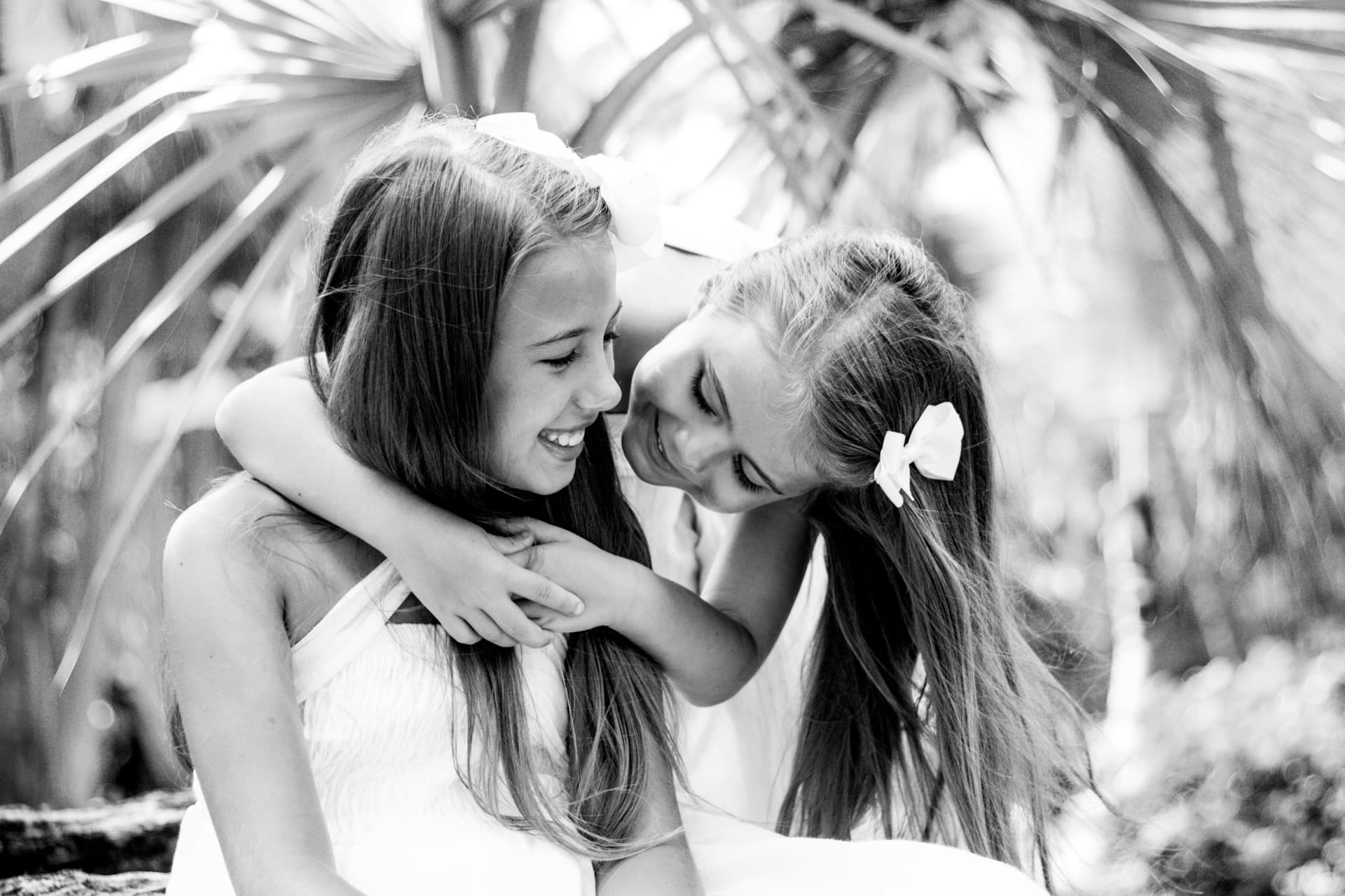 Two sisters sharing a tender moment, black and white portrait