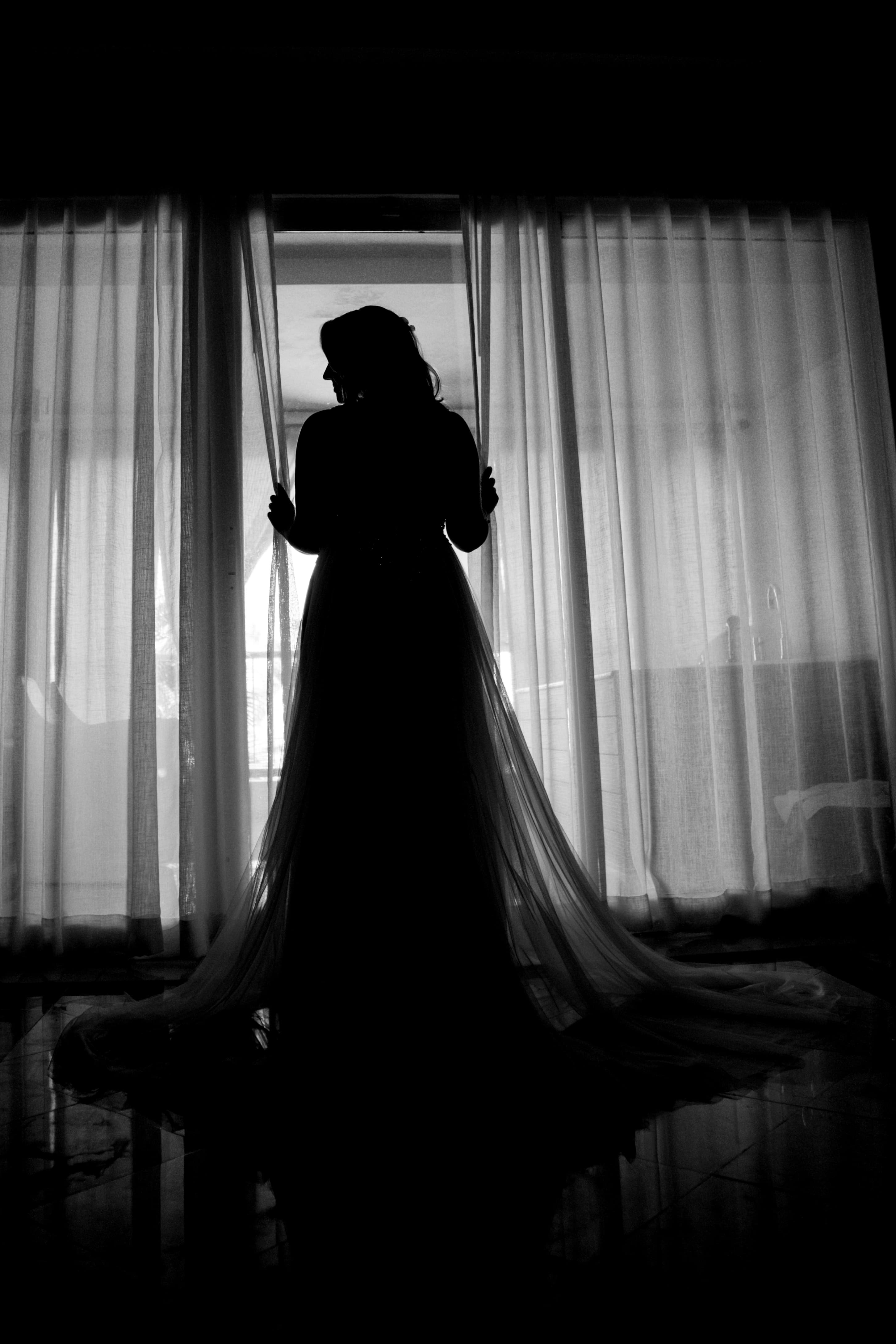 Bride and groom walking through a vineyard at dusk in golden Istrian light