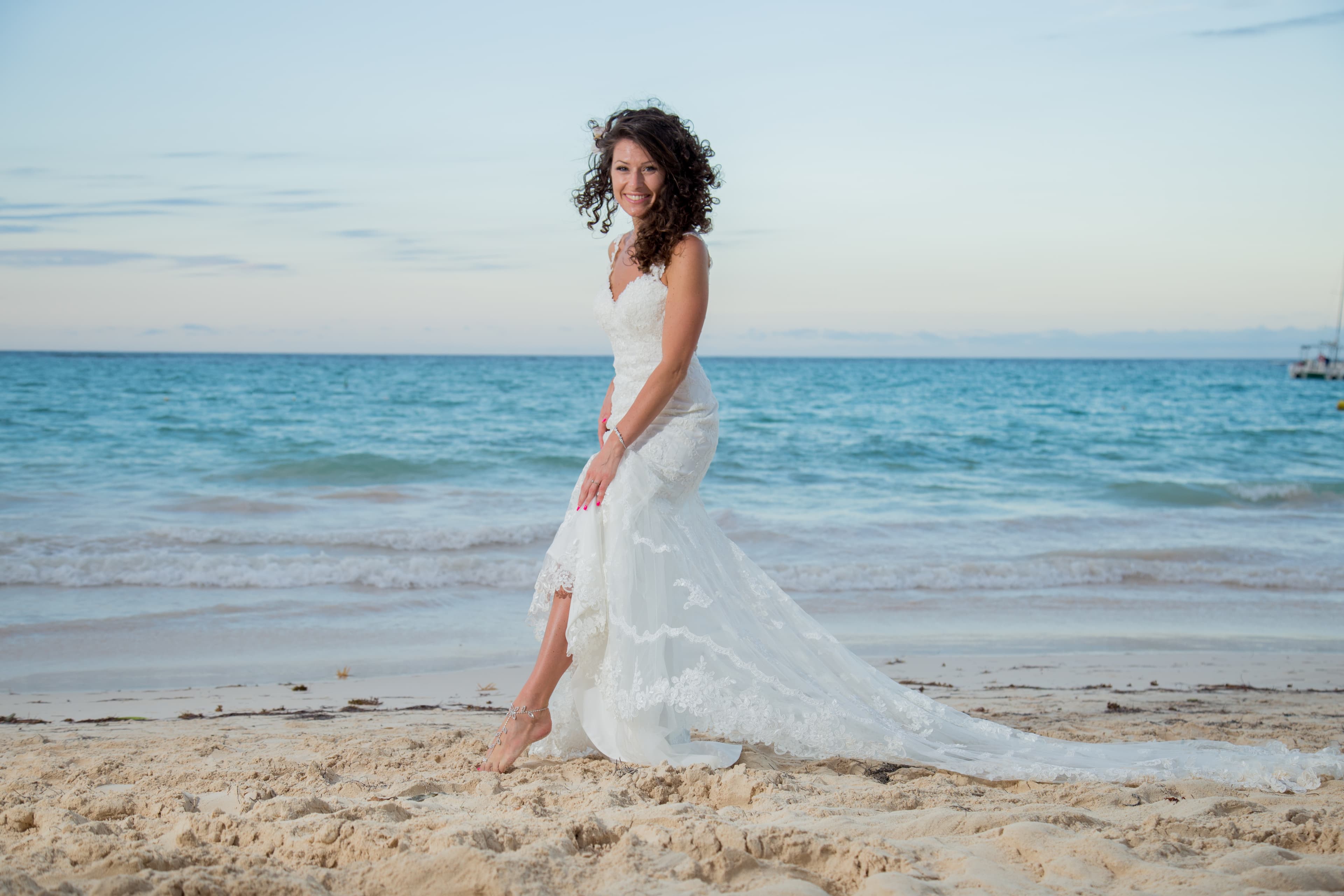 Bride and groom walking through a vineyard at dusk in golden Istrian light