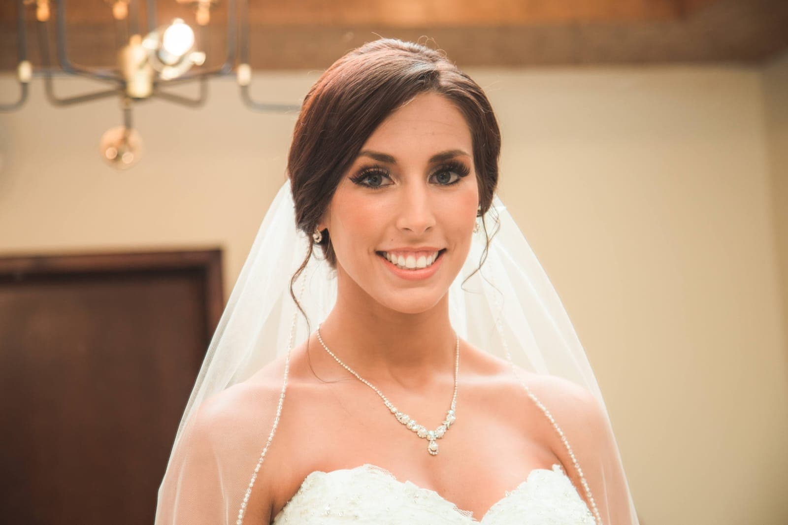 Bride and groom walking through a vineyard at dusk in golden Istrian light