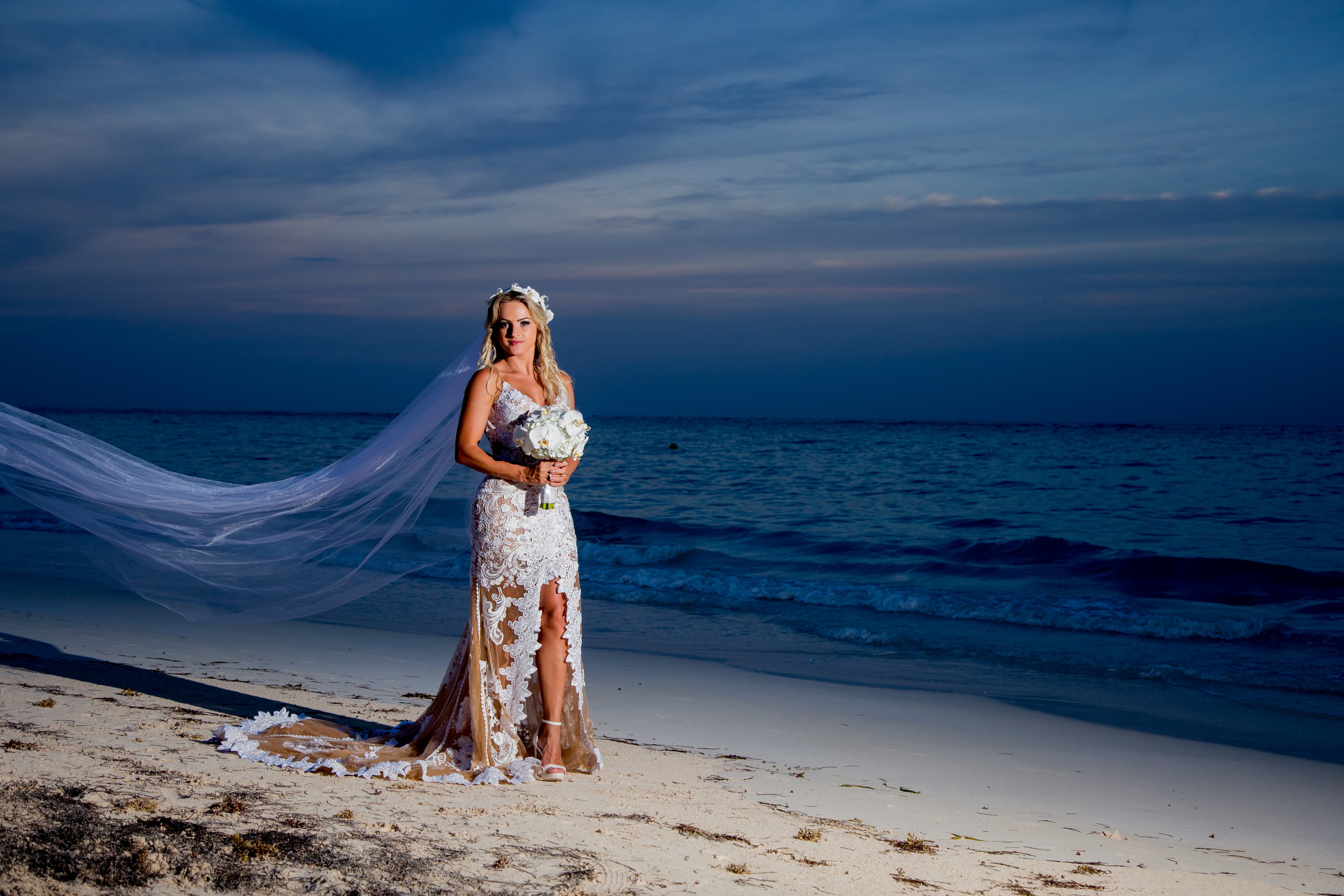 Bride and groom walking through a vineyard at dusk in golden Istrian light